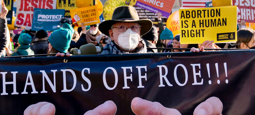 Stephen Parlato of Boulder, Colo., holds a sign that reads 